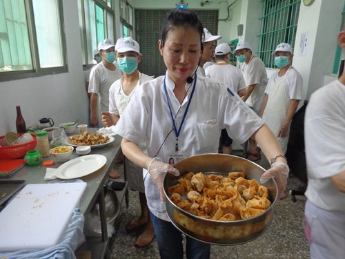 The baking instructor and inmates make traditional snacks together.