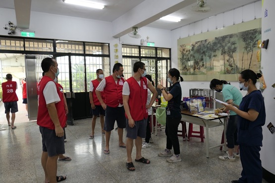 To improve herd immunity, public health officials administer influenza and COVID-19 vaccinations to inmates, reducing the risk of severe infection.